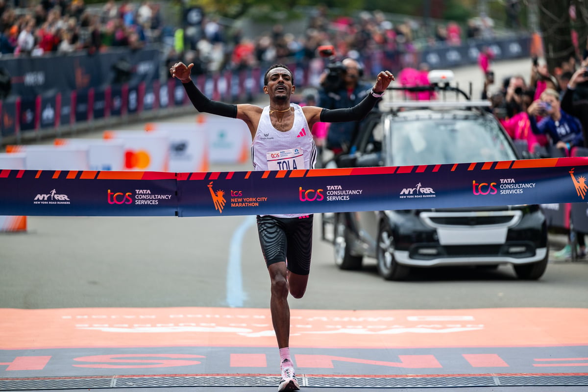 Tamira Tola breaking tape at 2023 TCS NYC Marathon.