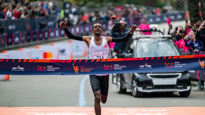 Tamira Tola breaking tape at 2023 TCS NYC Marathon.