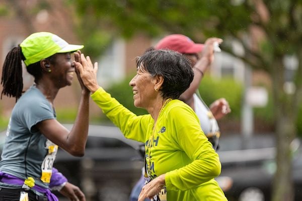 Community high-five along the RBC Brooklyn Half course.