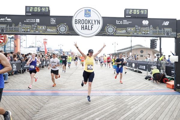 Runner celebrating at the RBC Brooklyn Half finish line.