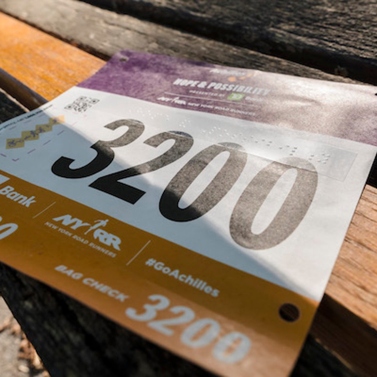 Image of Achilles race bib with braille.