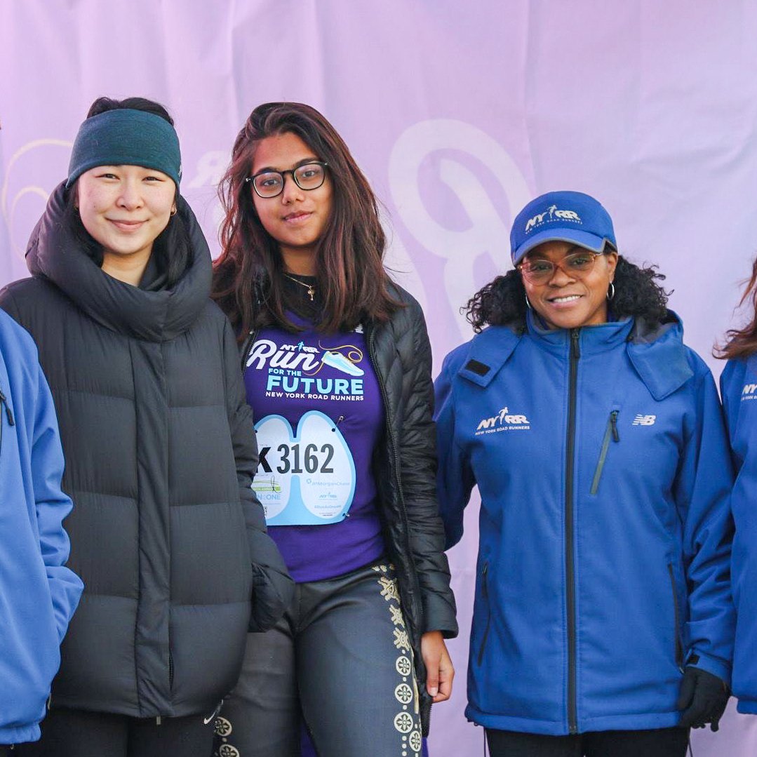 Two RFTF alumnae with NYRR staff inside tent at Run as One race