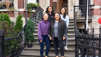 NYRR Contributors Circle members standing on steps at Harlem Run House November 2023