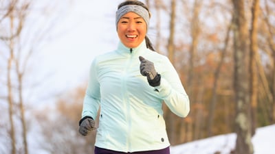 Carolyn Su running in snowy landscape