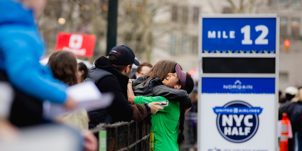 Runner and spectator embracing at 2024 United Airlines NYC Half