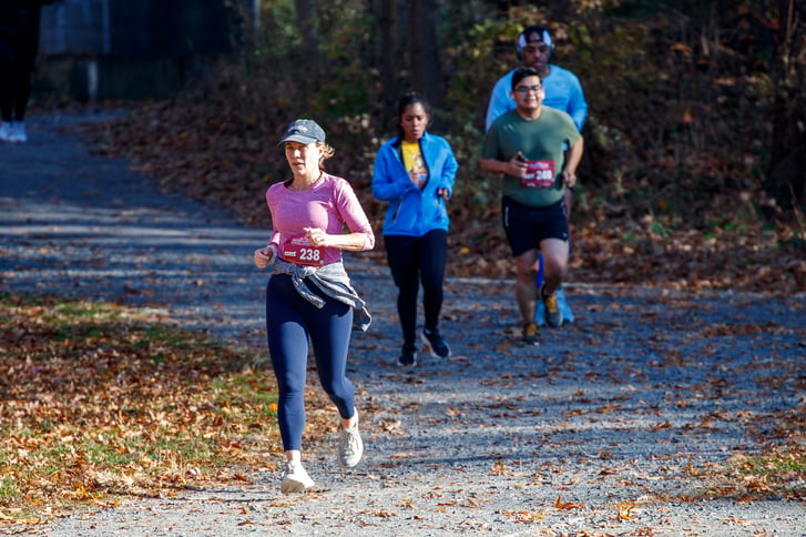 Several adult cross country runners at an NYRR race in Van Cortlandt Park on November 19 2023