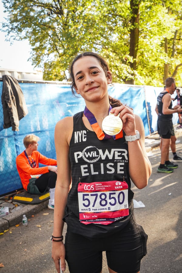 Elise Fernandez with 2024 TCS New York City Marathon medal vertical