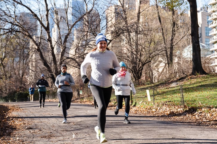 Runners in Central Park on bridle path on cold and sunny but not snowy day.