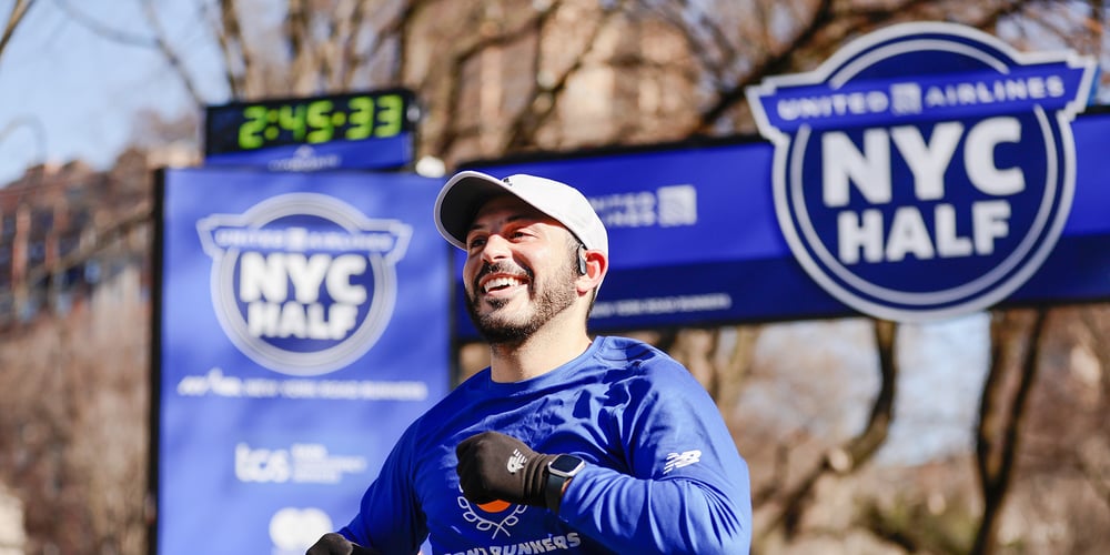 Bearded runner crosses the finish line of the United Airlines New York City Half