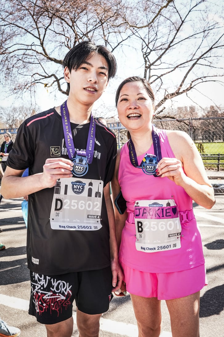 Runners Jackie Quan and Jefferson Lin with medals after 2024 United Airlines NYC Half