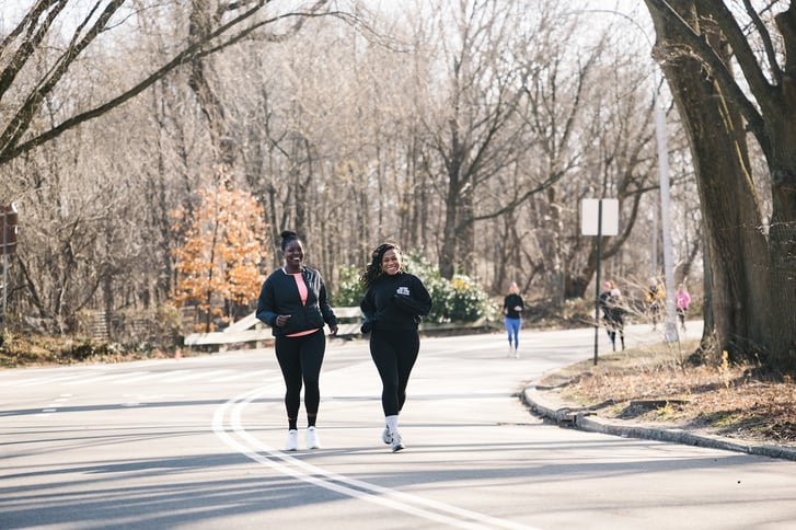 Cheryl Donald and Victoria Fortune running in Prospect Park landscape with roadway