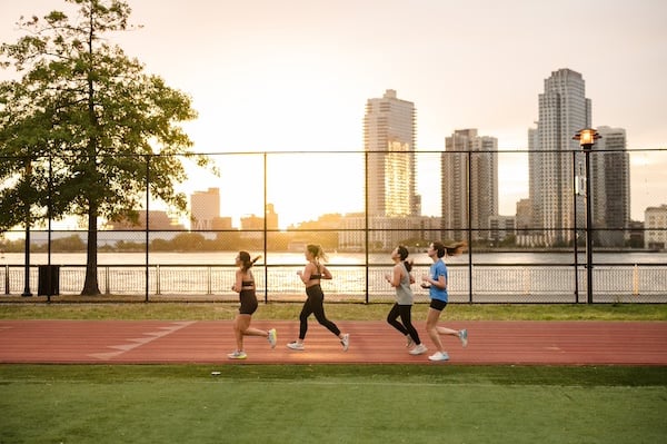 Group Training participants running along the East River track.