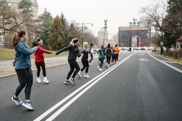 Group Training participants doing dynamic warm-up in Prospect Park.
