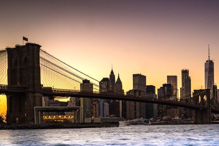 Brooklyn Bridge with sunset and Lower Manhattan skyline in background