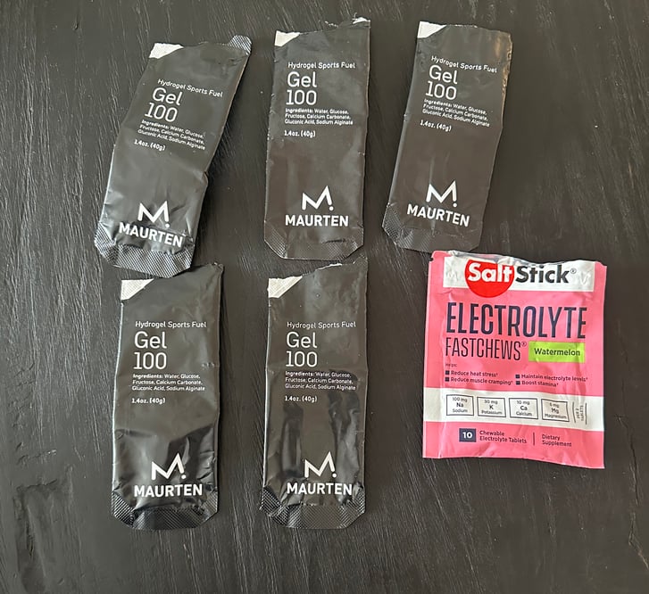 Maurten gels and chews wrappers on dark background