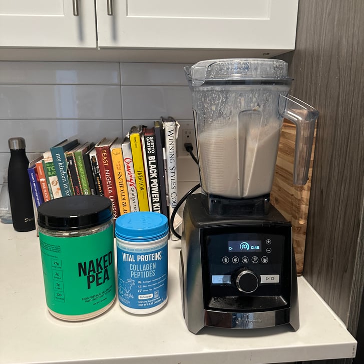 Blender, cookbooks, ingredients in kitchen