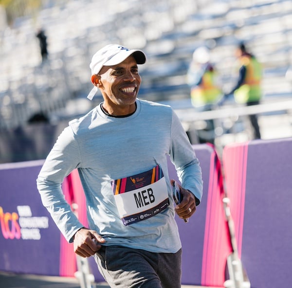 Meb running near the finish line during marathon week.