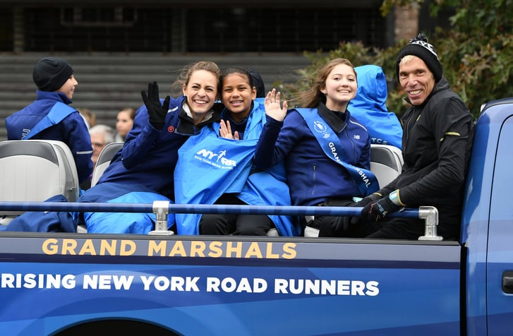 Jenny Simpson and youth runner on back of the pace truck for the marathon