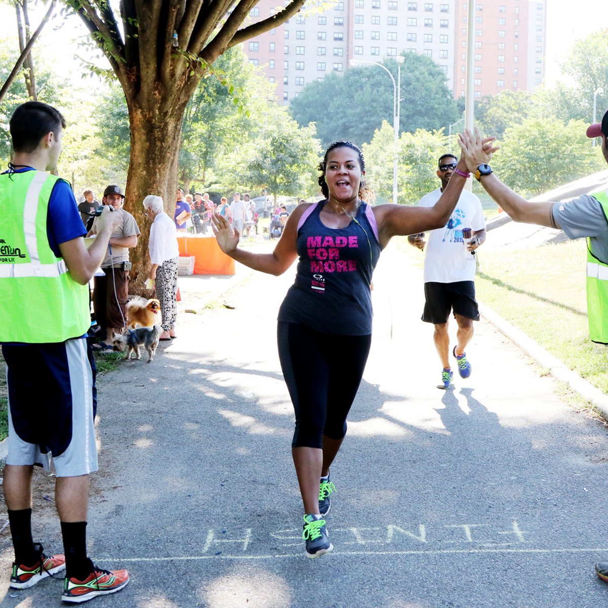 A runner high-fives event staff at St. Mary's Park