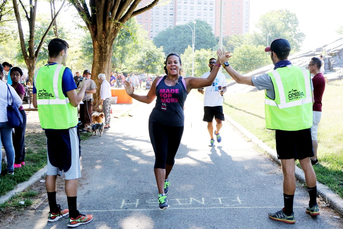 A runner high-fives event staff at St. Mary's Park