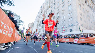 Runner waving to camera