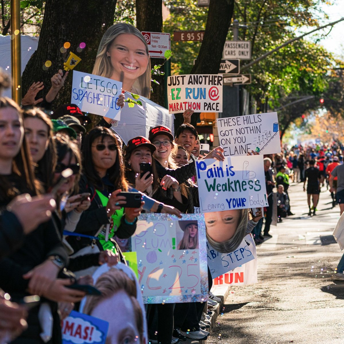 People holding signs in the crowd