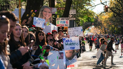 People holding signs in the crowd