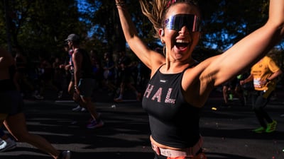 Runner with her arms up