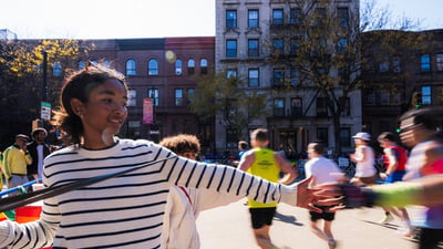 Crowd members high five-ing runners