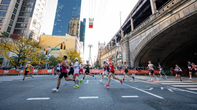 Runners running out from under bridge