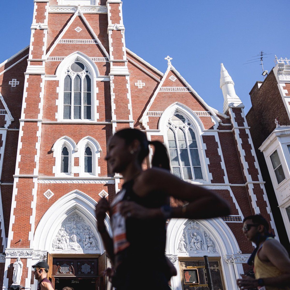 Runners in front of church