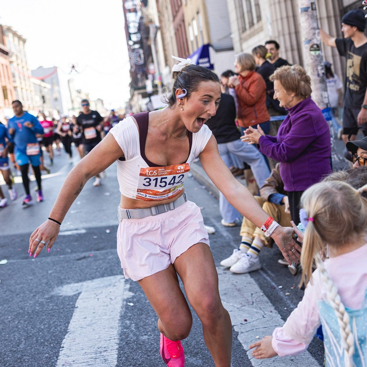 Runner high-fiving kids in crowd
