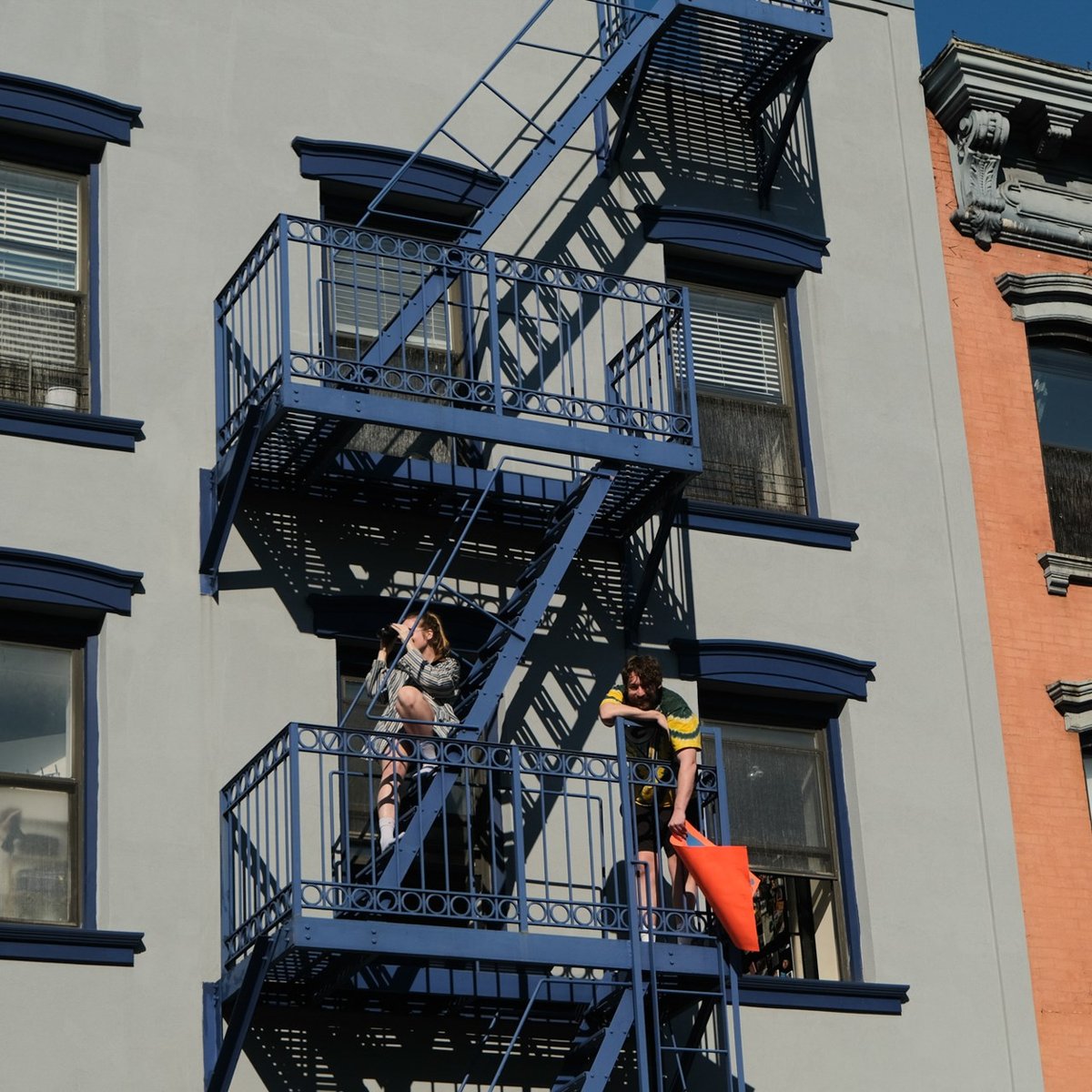 Crowd members on fire escapes