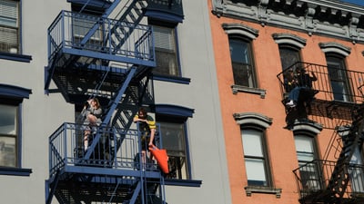 Crowd members on fire escapes
