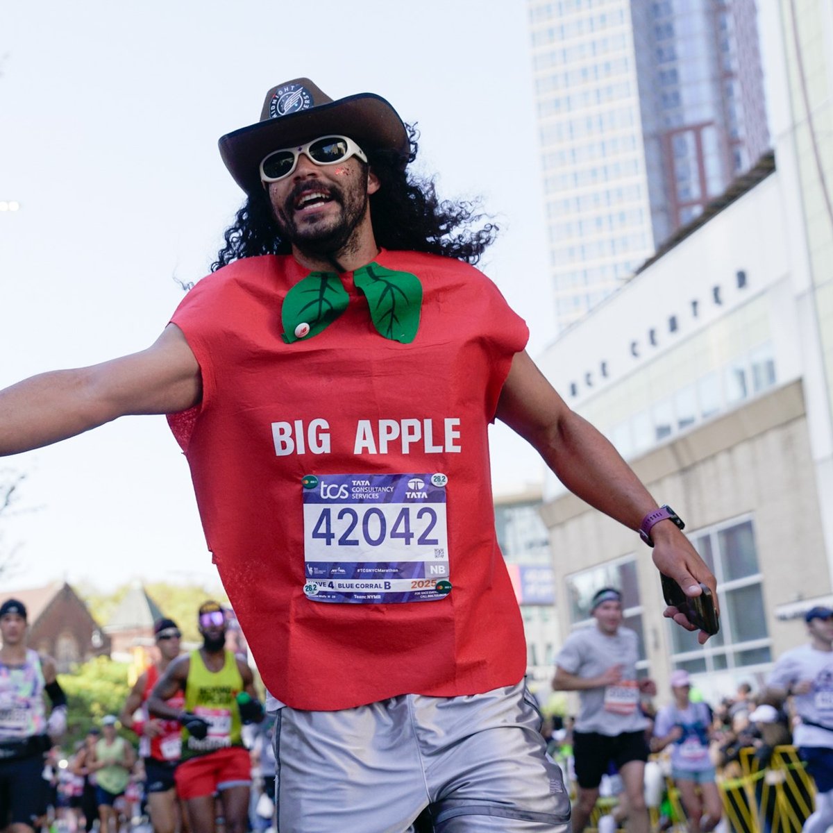 Runner wearing big apple costume