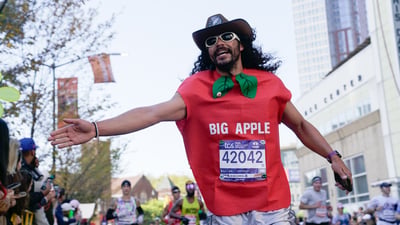 Runner wearing big apple costume