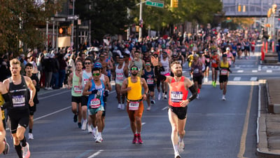 Crowd of runners with one runner waving