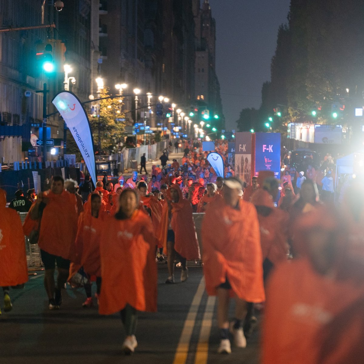A sea of runners in matching finisher ponchos amongst the city streets