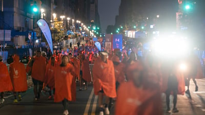A sea of runners in matching finisher ponchos amongst the city streets