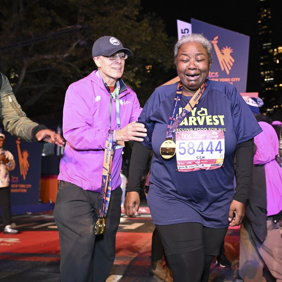 A final finisher cries as she goes through the finish line area