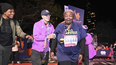 A final finisher cries as she goes through the finish line area