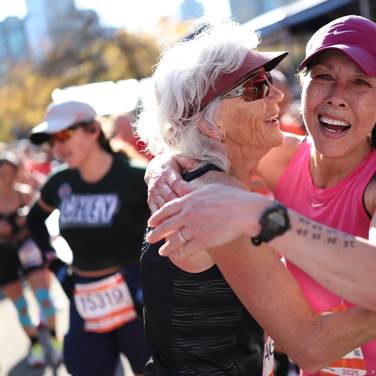 Two women embrace for a hug at the finish line of the TCS New York City Marathon
