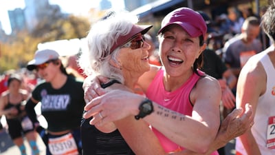 Two women embrace for a hug at the finish line of the TCS New York City Marathon