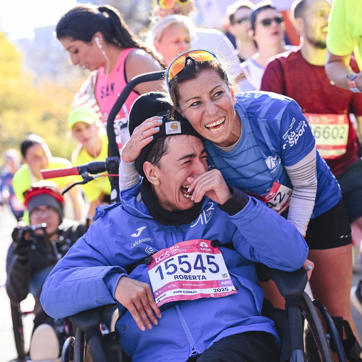A female AWD athlete in a wheelchair cries and is elated at the finish line of the TCS New York City Marathon