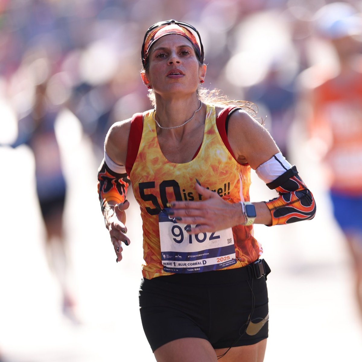 A woman running towards the finish line at the TCS New York City Marathon