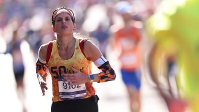 A woman running towards the finish line at the TCS New York City Marathon