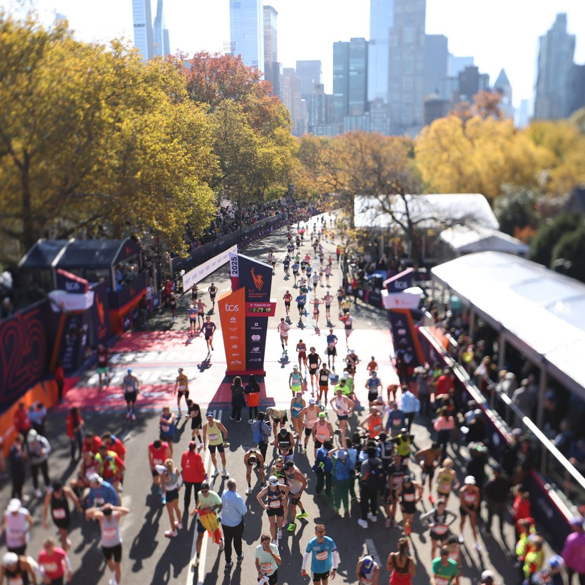 An overhead shot of runners at the TCS New York City Marathon finish line