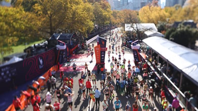 An overhead shot of runners at the TCS New York City Marathon finish line