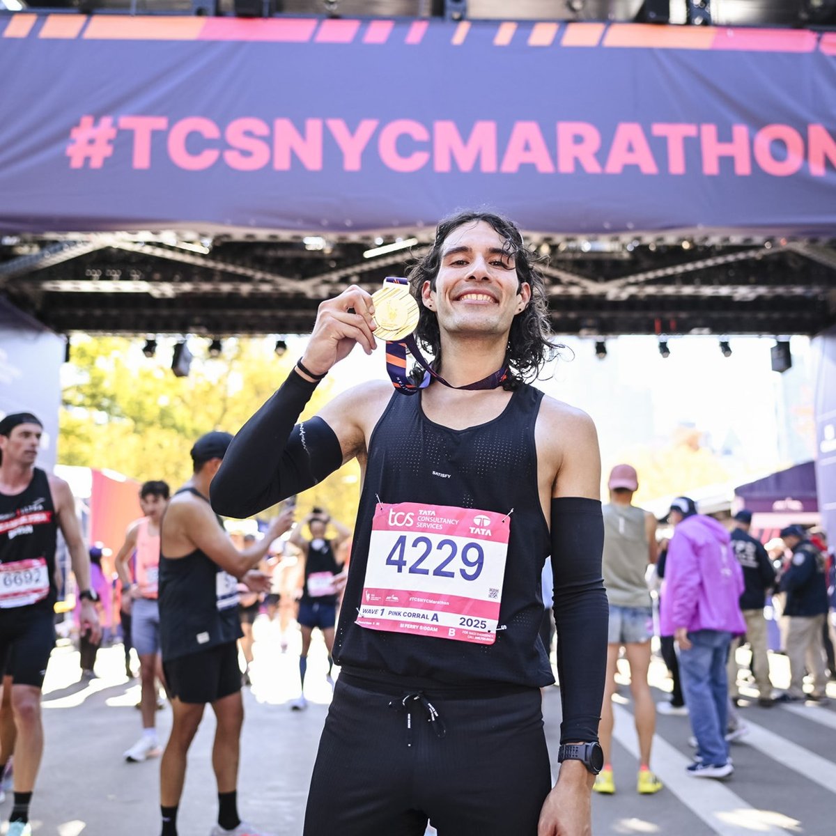 Top nonbinary runner Daniel Mata holding medal after finishing 2025 TCS NYC Marathon