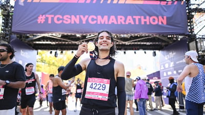 Top nonbinary runner Daniel Mata holding medal after finishing 2025 TCS NYC Marathon